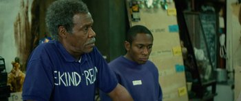 Movie still from “Be Kind Rewind” (2008), directed by Michel Gondry – Two men standing next to each other in front of a wall; Medium shot, Over the shoulder angle