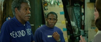 Movie still from “Be Kind Rewind” (2008), directed by Michel Gondry – A man standing next to another man in a room; Close Up shot, Over the shoulder angle