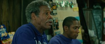Movie still from “Be Kind Rewind” (2008), directed by Michel Gondry – Two men sitting next to each other in front of a wall; Close Up shot, Low angle