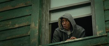 Movie still from “Be Kind Rewind” (2008), directed by Michel Gondry – A young man looking out of a window wearing a hooded sweatshirt; Close Up shot, Low angle