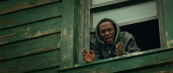 Movie still from “Be Kind Rewind” (2008), directed by Michel Gondry – A man in a hooded jacket looking out of a window; Close Up shot, Low angle