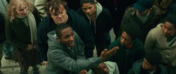 Movie still from “Be Kind Rewind” (2008), directed by Michel Gondry – A group of young people standing around each other in a room; Medium shot, High angle
