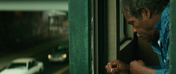 Movie still from “Be Kind Rewind” (2008), directed by Michel Gondry – A man standing on a train looking out of a window; Close Up shot, Low angle