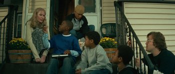 Movie still from “Be Kind Rewind” (2008), directed by Michel Gondry – A group of young men sitting on the steps of a house; Medium shot, Low angle
