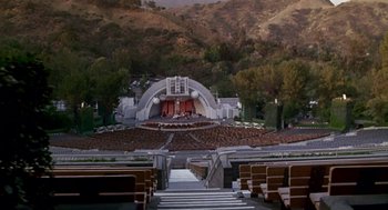 Movie still from “Beaches” (1988), directed by Garry Marshall – An outdoor stage with seats in front of it; Extreme Wide shot, High angle