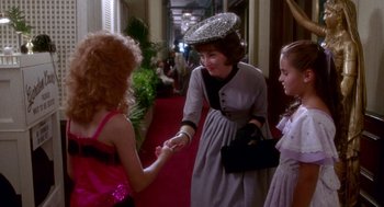 Movie still from “Beaches” (1988), directed by Garry Marshall – A woman and two young girls are shaking hands; Medium shot, Over the shoulder angle