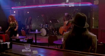 Movie still from “Beaches” (1988), directed by Garry Marshall – A group of people playing instruments in a room; Wide shot, High angle