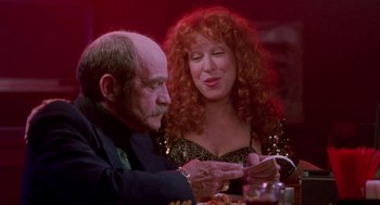 Movie still from “Beaches” (1988), directed by Garry Marshall – An older man and a woman sitting at a dinner table; Medium shot, Over the shoulder angle