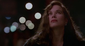 Movie still from “Beaches” (1988), directed by Garry Marshall – A woman looking up into the air with lights in the background; Close Up shot, Low angle