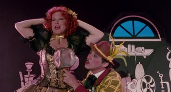 Movie still from “Beaches” (1988), directed by Garry Marshall – A man and a woman dressed up in costumes; Medium shot, Over the shoulder angle