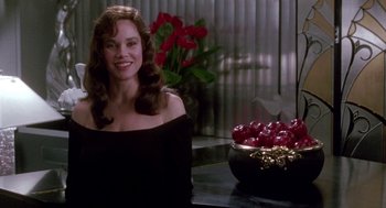 Movie still from “Beaches” (1988), directed by Garry Marshall – A woman sitting in front of a bowl of apples; Medium shot, Over the shoulder angle