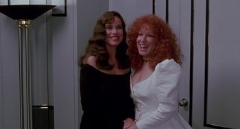 Movie still from “Beaches” (1988), directed by Garry Marshall – Two women standing next to each other in a room; Medium shot, High angle