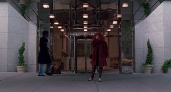 Movie still from “Beaches” (1988), directed by Garry Marshall – A woman standing in front of an entrance to a building; Wide shot, Low angle