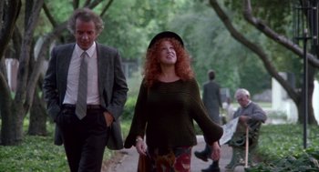 Movie still from “Beaches” (1988), directed by Garry Marshall – An older man and woman walking down a sidewalk; Medium shot, Low angle