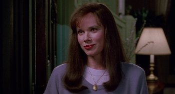 Movie still from “Beaches” (1988), directed by Garry Marshall – A person with long hair wearing a necklace; Close Up shot, Over the shoulder angle