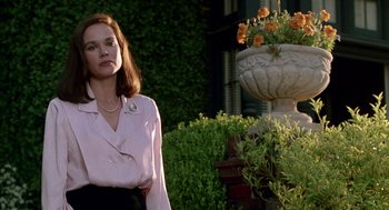 Movie still from “Beaches” (1988), directed by Garry Marshall – A woman standing in front of a flower pot; Medium shot, Low angle