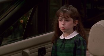 Movie still from “Beaches” (1988), directed by Garry Marshall – A young girl sitting in the back seat of a car; Close Up shot, High angle