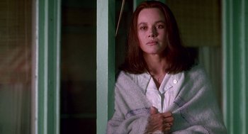 Movie still from “Beaches” (1988), directed by Garry Marshall – A woman standing in front of a window; Close Up shot, Low angle