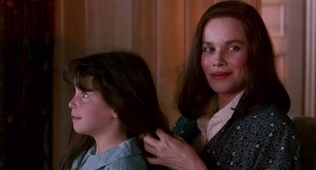 Movie still from “Beaches” (1988), directed by Garry Marshall – A young girl and an older woman are combing each other's hair; Close Up shot, Over the shoulder angle