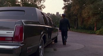 Movie still from “Beaches” (1988), directed by Garry Marshall – A man walking down the street next to a limo; Wide shot, Low angle