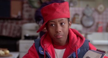 Movie still from “Beat Street” (1984), directed by Stan Lathan – A young man wearing a red hat and a red jacket; Close Up shot, High angle