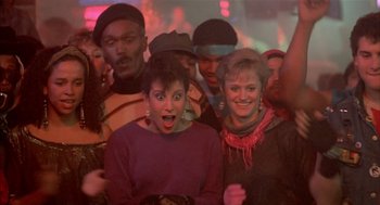 Movie still from “Beat Street” (1984), directed by Stan Lathan – A group of people standing in front of a crowd; Medium shot, High angle