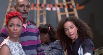 Movie still from “Beat Street” (1984), directed by Stan Lathan – A man and a woman standing next to each other; Close Up shot, Over the shoulder angle