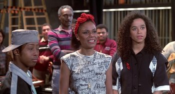 Movie still from “Beat Street” (1984), directed by Stan Lathan – A group of people standing in front of a building; Medium shot, High angle
