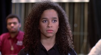 Movie still from “Beat Street” (1984), directed by Stan Lathan – A young woman with long curly black hair; Close Up shot, High angle