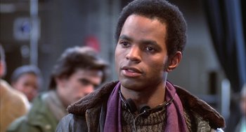Movie still from “Beat Street” (1984), directed by Stan Lathan – A young man with headphones and a purple scarf; Close Up shot, Over the shoulder angle