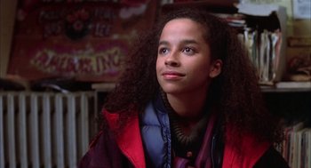 Movie still from “Beat Street” (1984), directed by Stan Lathan – A young woman with long curly black hair looking up; Close Up shot, Low angle