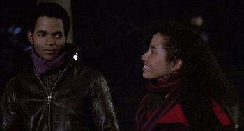 Movie still from “Beat Street” (1984), directed by Stan Lathan – A man and a woman smiling at each other; Close Up shot, Over the shoulder angle