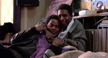 Movie still from “Beat Street” (1984), directed by Stan Lathan – Two people are hugging each other in a room; Medium shot, Low angle