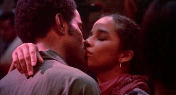 Movie still from “Beat Street” (1984), directed by Stan Lathan – A man and a woman kissing each other in front of a wall; Close Up shot, Low angle