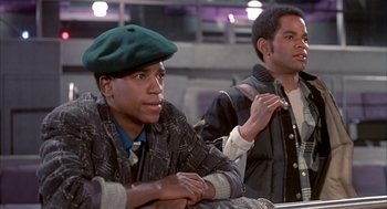 Movie still from “Beat Street” (1984), directed by Stan Lathan – Two young men sitting next to each other; Medium shot, Low angle