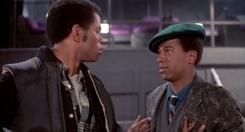 Movie still from “Beat Street” (1984), directed by Stan Lathan – Two men talking to each other while wearing ties; Close Up shot, Over the shoulder angle