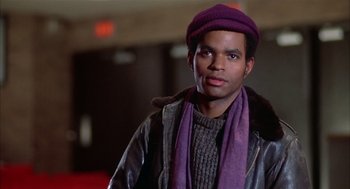 Movie still from “Beat Street” (1984), directed by Stan Lathan – A man wearing a purple hat and a purple scarf; Close Up shot, Low angle
