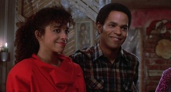 Movie still from “Beat Street” (1984), directed by Stan Lathan – A man and a woman standing next to each other in a room; Close Up shot, Low angle