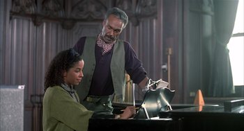 Movie still from “Beat Street” (1984), directed by Stan Lathan – A man and a woman are playing piano together; Medium shot, High angle