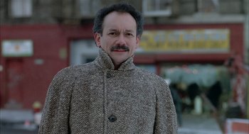 Movie still from “Beat Street” (1984), directed by Stan Lathan – A person wearing a coat; Close Up shot, Low angle