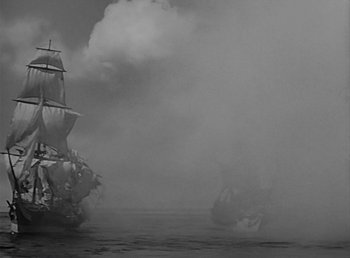 Movie still from “Beau Geste” (1939), directed by William A. Wellman – A black and white photo of two ships in the water; Extreme Wide shot, Low angle