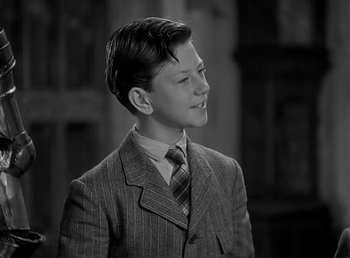 Movie still from “Beau Geste” (1939), directed by William A. Wellman – A young man in a suit and tie; Medium shot, High angle
