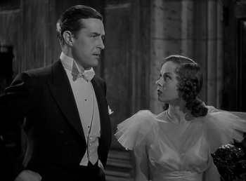Movie still from “Beau Geste” (1939), directed by William A. Wellman – A man and a woman standing next to each other in front of a building; Medium shot, Low angle