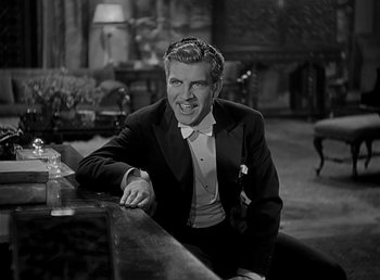 Movie still from “Beau Geste” (1939), directed by William A. Wellman – A black and white photo of a man sitting at a bar; Medium shot, High angle