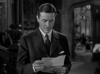 Movie still from “Beau Geste” (1939), directed by William A. Wellman – A black and white photo of a man reading a piece of paper; Close Up shot, Low angle