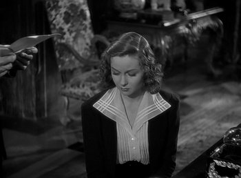 Movie still from “Beau Geste” (1939), directed by William A. Wellman – A black and white photo of a woman in a suit; Medium shot, High angle
