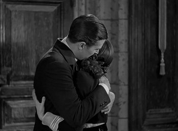 Movie still from “Beau Geste” (1939), directed by William A. Wellman – A man and a woman embracing each other; Medium shot, High angle