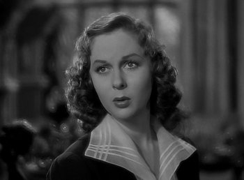 Movie still from “Beau Geste” (1939), directed by William A. Wellman – A black - and - white photo of a woman with curly hair; Close Up shot, Low angle