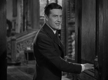 Movie still from “Beau Geste” (1939), directed by William A. Wellman – A black and white photo of a man in a suit and tie; Medium shot, Over the shoulder angle