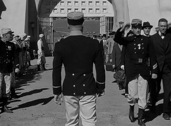 Movie still from “Beau Geste” (1939), directed by William A. Wellman – A black and white photo of a man in a military uniform; Wide shot, Over the shoulder angle